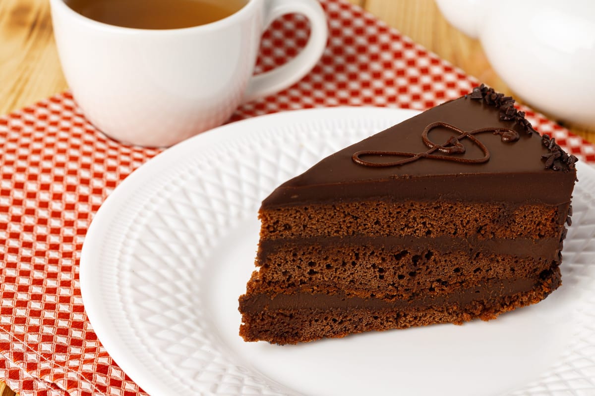 piece-of-chocolate-cake-on-white-plate-on-table-2025-02-24-22-24-30-utc