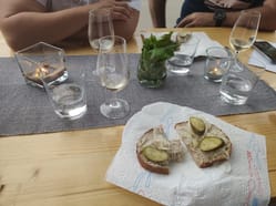 Pohled na stůl s vínem a škvarkouvou pomazánkou na chlebu